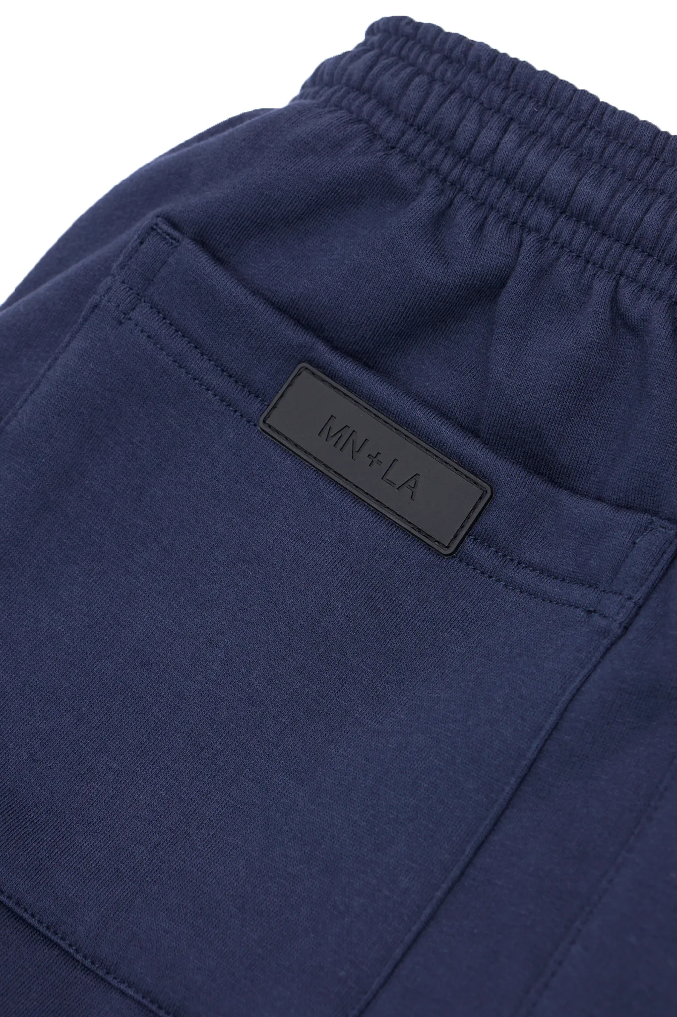 "M'$ & BEYOND" TRACK PANTS IN NAVY BLUE